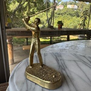 Solid brass figurine of golfer swinging golf club